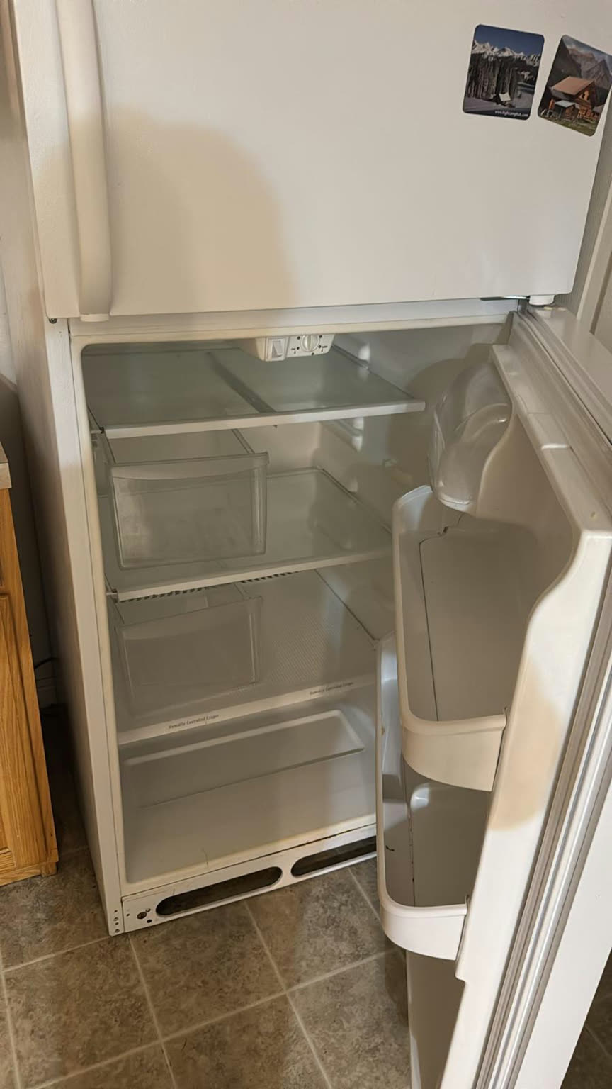 Full refrigerator interior after cleaning, with clear glass shelves, wiped crisper drawers, and a fresh, sanitized finish